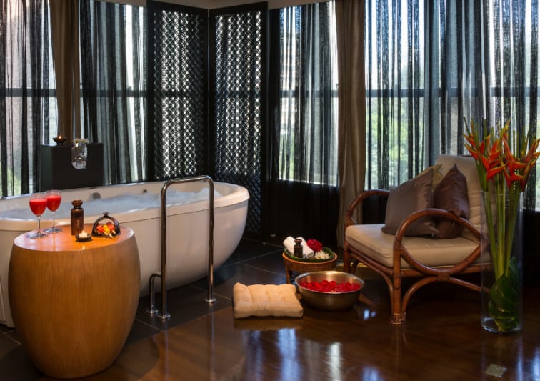 Quarto do Anantara Spa com banheira de imersão e poltronas e bacia para escalda pés.
